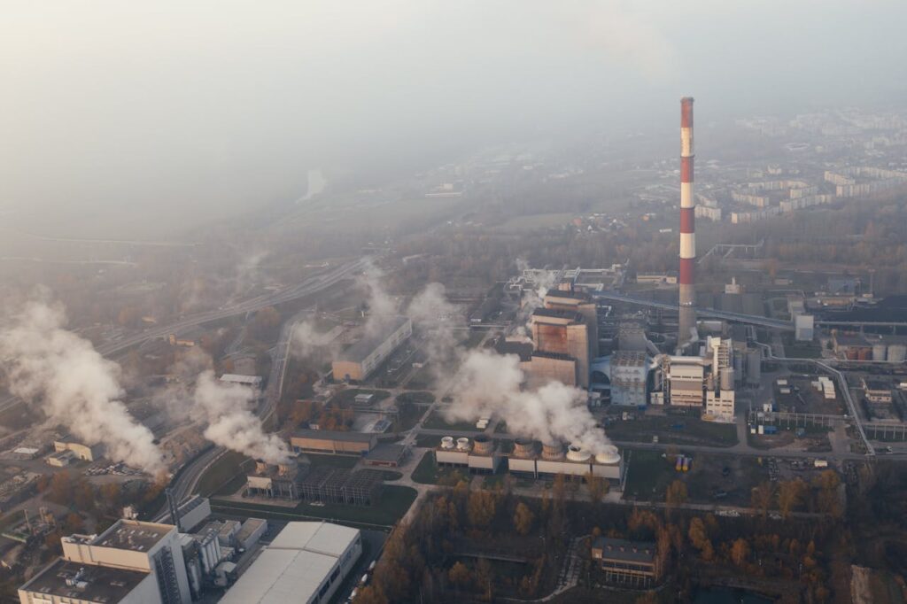 Aerial shot of an industrial plant in Poznań emitting smoke and pollution.